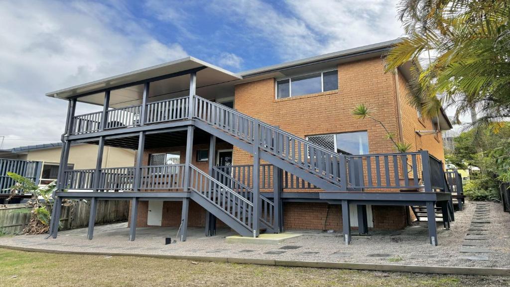 a house with a staircase in front of it at The Perch - Lifestyle Yamba in Yamba