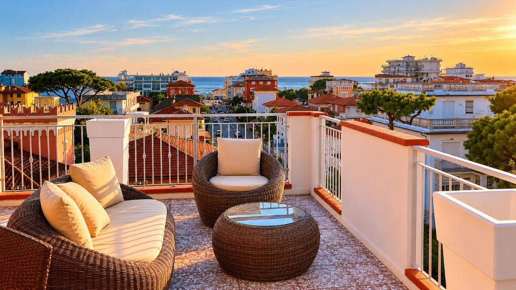 a balcony with two chairs and a table and a view of the city at Hotel Verbena in Lido di Camaiore