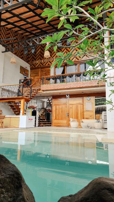 a large swimming pool with a building in the background at Dayunan in Bacolod