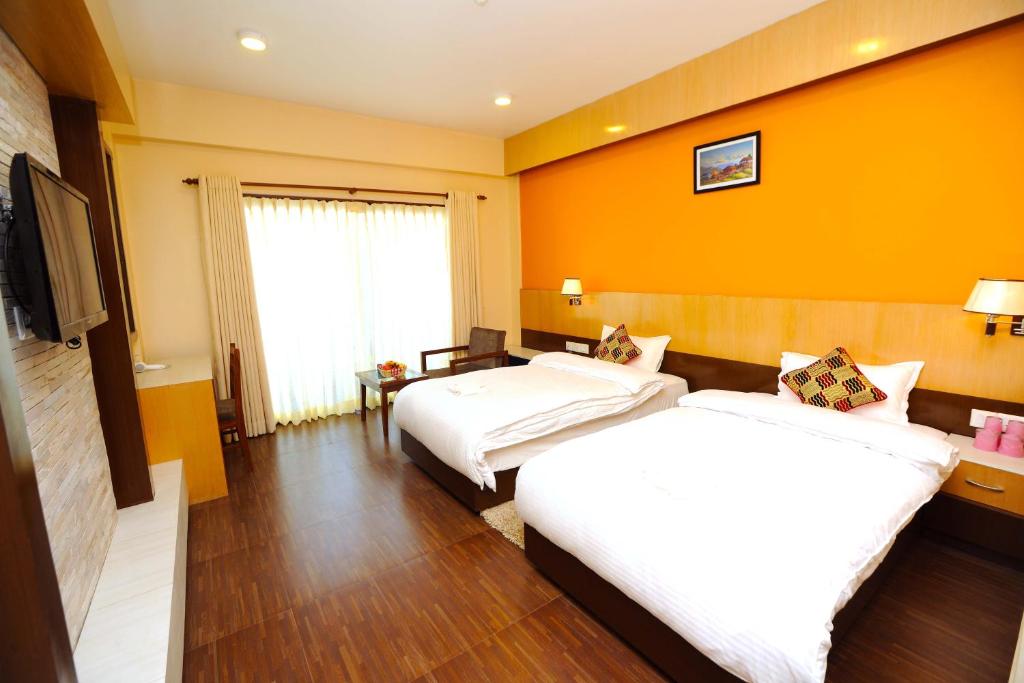 Rúm í herbergi á Hotel Queens Park