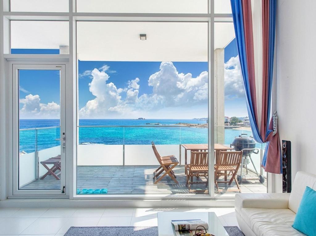 a living room with a view of the ocean at Vinolian Ocean View Spa Pension in Goseong