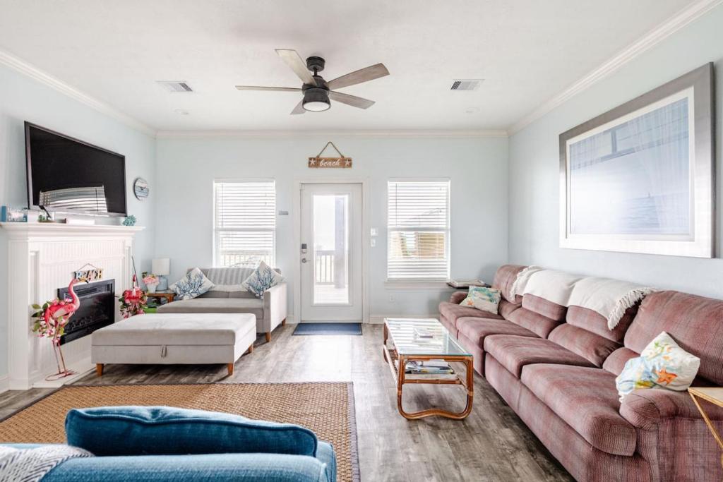 a living room with a couch and a ceiling fan at Gulf Views Steps to Beach 2 King Beds 3Bd 2Bth in Bolivar Peninsula