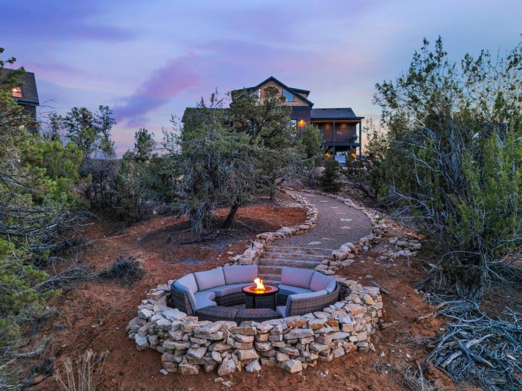 a fire pit in the yard of a house at Sandstone Pointe, Elegance Among the Cliffs in Mount Carmel