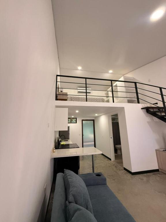 a living room with a couch and a loft at Apartamentos Aledu in Brasilito