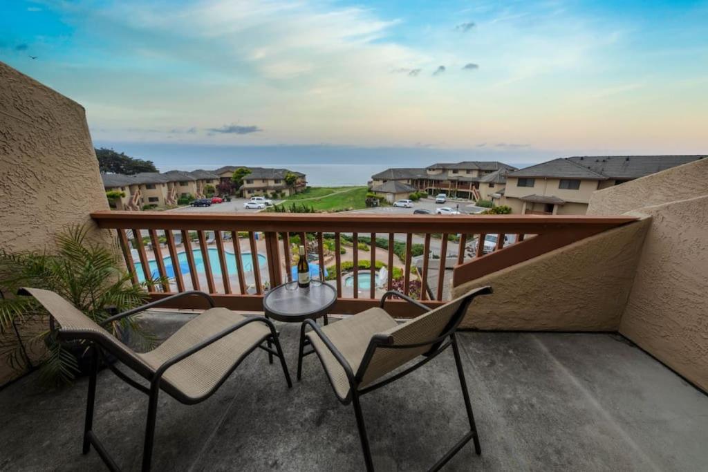 a balcony with two chairs and a table on it at Seascape Ocean View Condo in Aptos