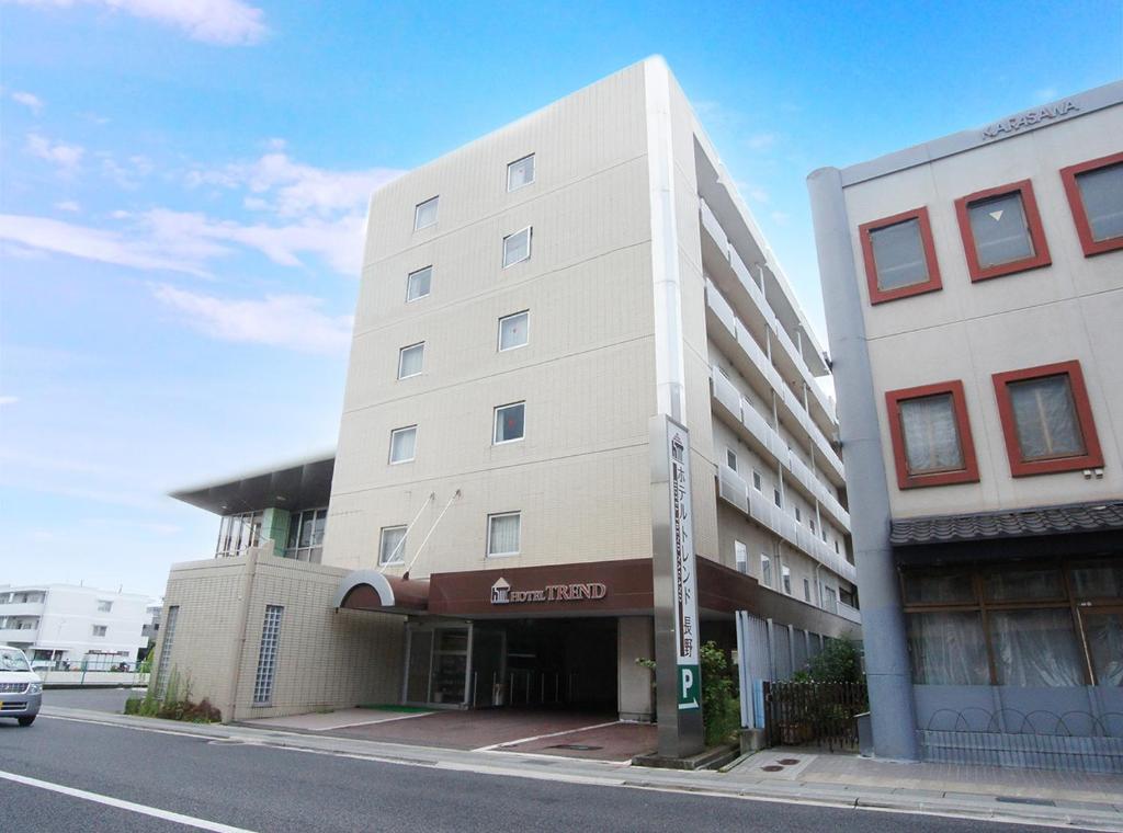 a tall white building on the side of a street at Hotel Trend Nagano in Nagano