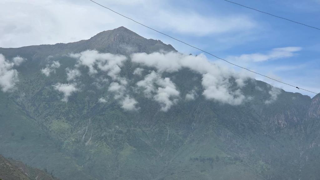 a mountain with clouds on top of it at La casona de aquiles in Palle Nuevo