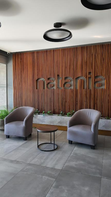 two chairs and a table in a lobby at Lomajobava in Godoy Cruz