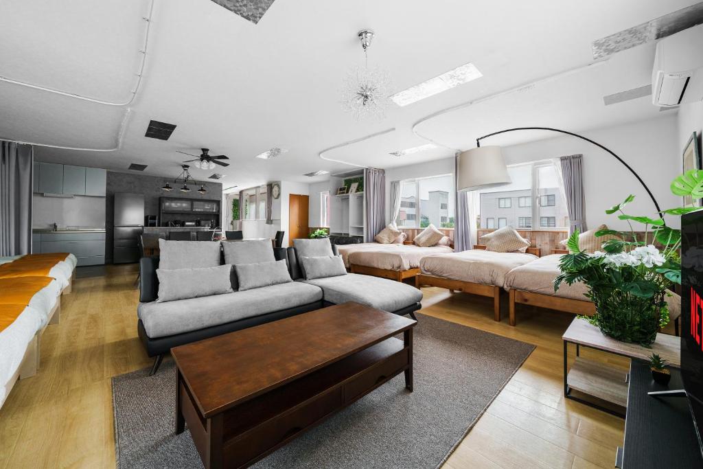 a living room with two couches and a table at Snowm in Asahikawa