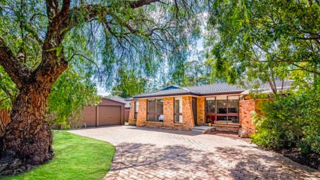 a brick house with a tree in front of it at The Nest in Bidwill