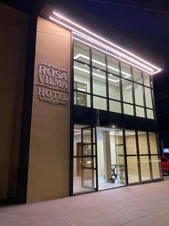a building with a sign on the side of it at Rosa Vilma Hotel in Chapadão do Sul