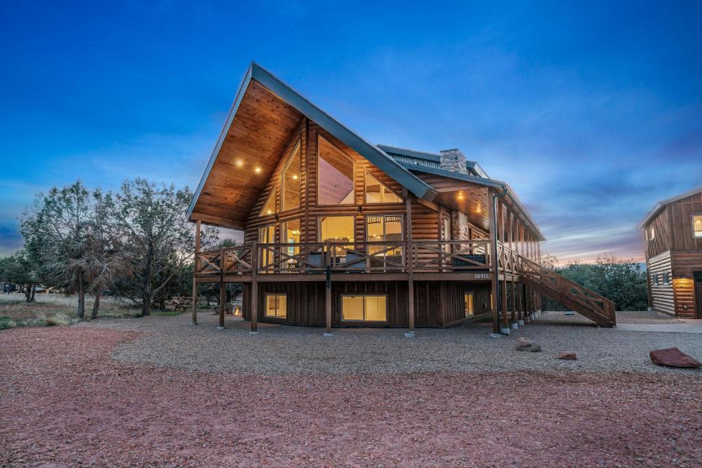a large wooden house with a large deck at Copper Rock Ridge- Luxury, Pool Table, Hot Tub between Zion and Bryce in Orderville