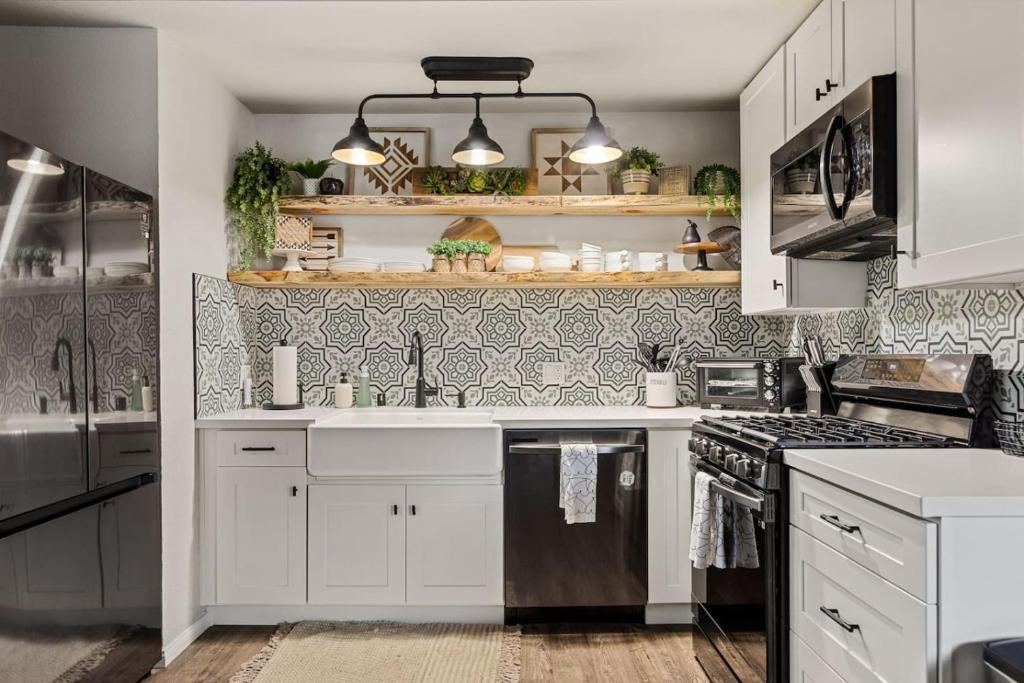 a kitchen with white cabinets and a sink at Brunos Bungalow in Big Bear Lake