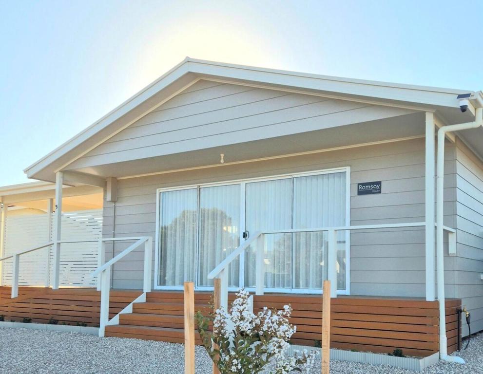 a house with a large window and a wooden porch at Ramsay House in Port Vincent