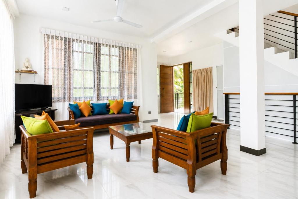 a living room with two chairs and a couch at Ivy Garden Retreat in Gampola