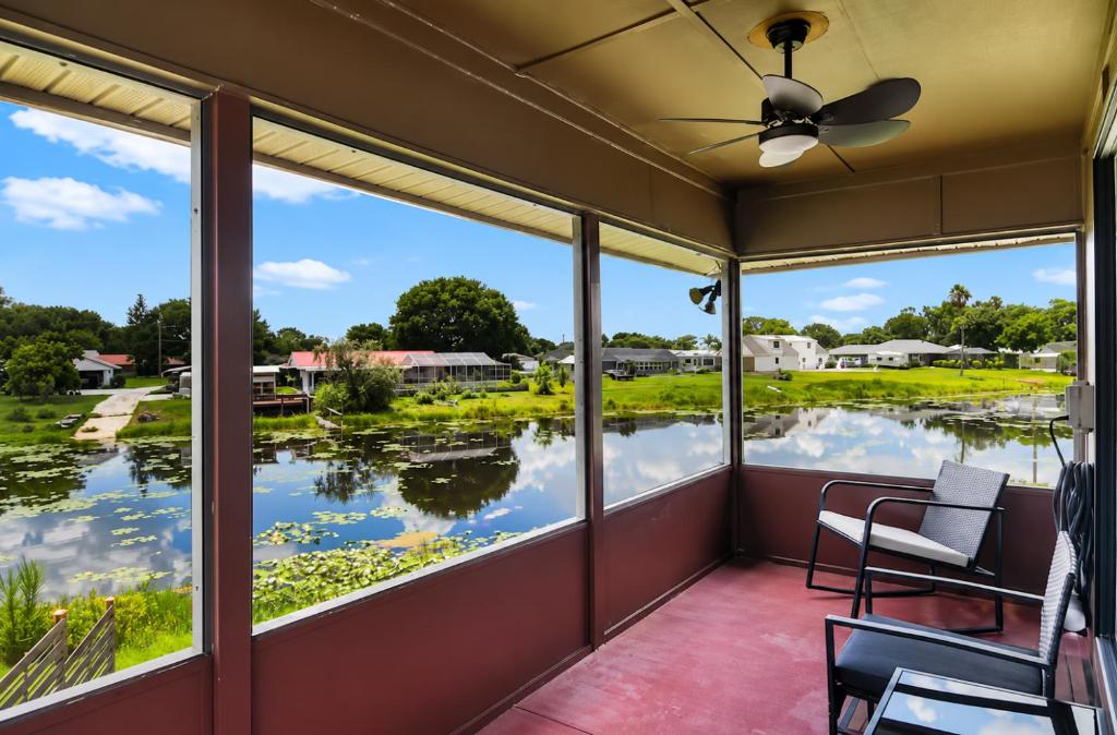 a screened porch with a view of the water at Cozy Lakefront Home in Lake Wales