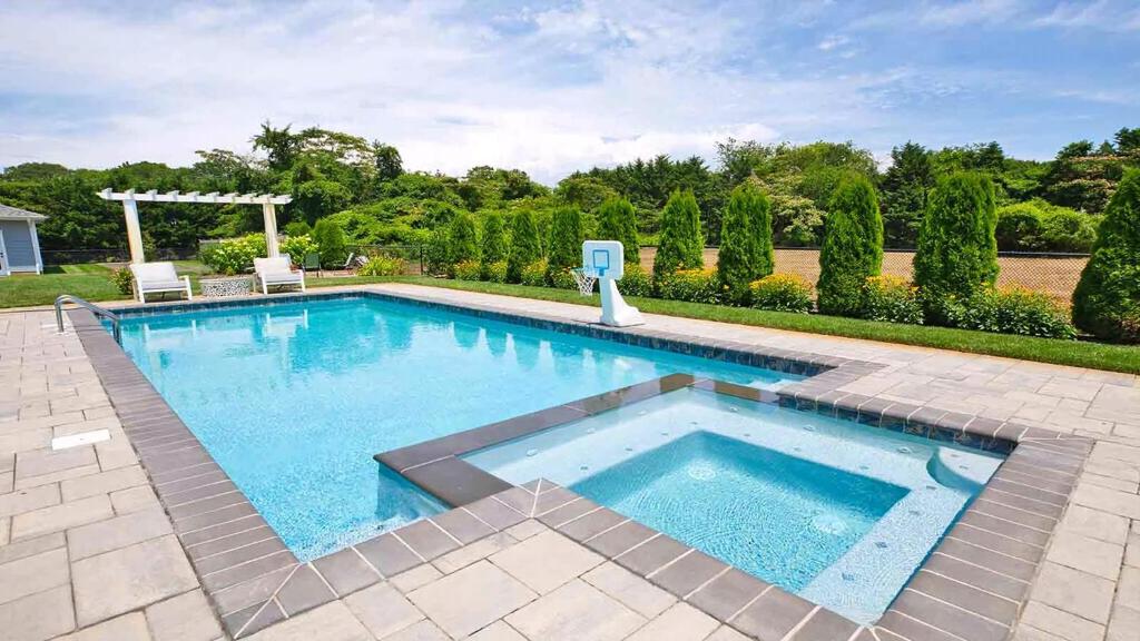 a large swimming pool with two chairs in a yard at Welahpu Beach in Cape May