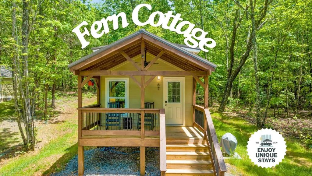 a tiny house in the woods with the words farm cottage at Fern Cottage in Menlo GA in Rising Fawn