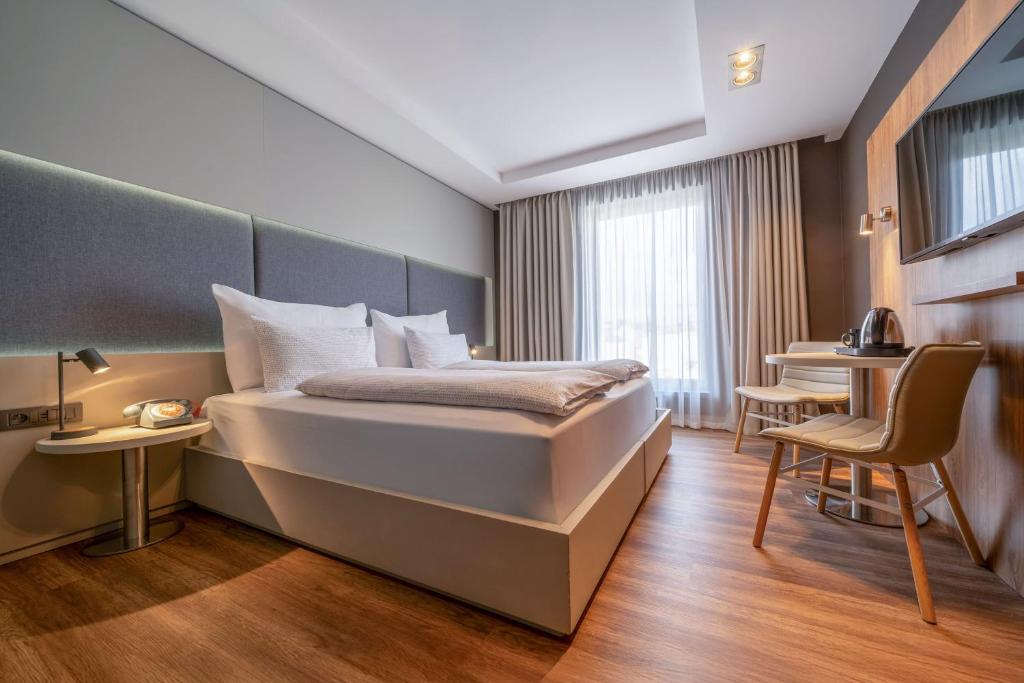 a hotel room with a bed and a table at INNSiDE by Meliá Prague Old Town in Prague