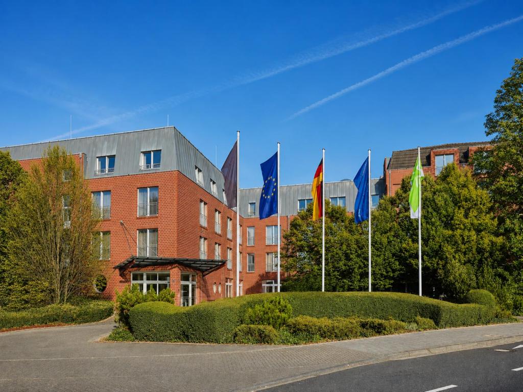 a row of flags in front of a building at Sunday Hotel Köln Hürth in Hürth