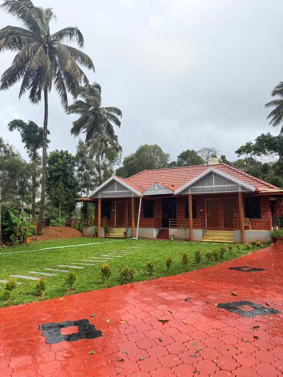 a house with a palm tree in front of it at VIVIPRA Habitat, Coorg in Madikeri