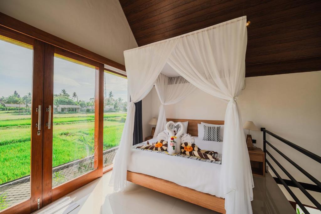 a bed with teddy bears in a room with a window at The Solas Villa Ubud in Ubud