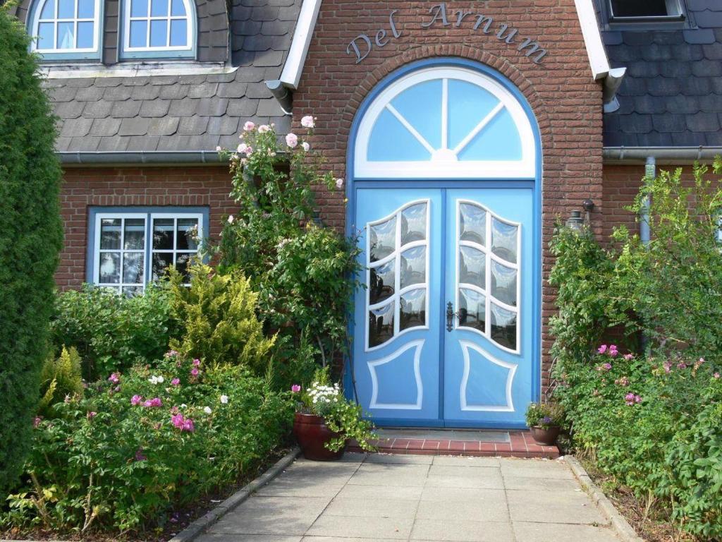 a blue front door of a brick house at Dethlefs in Nebel