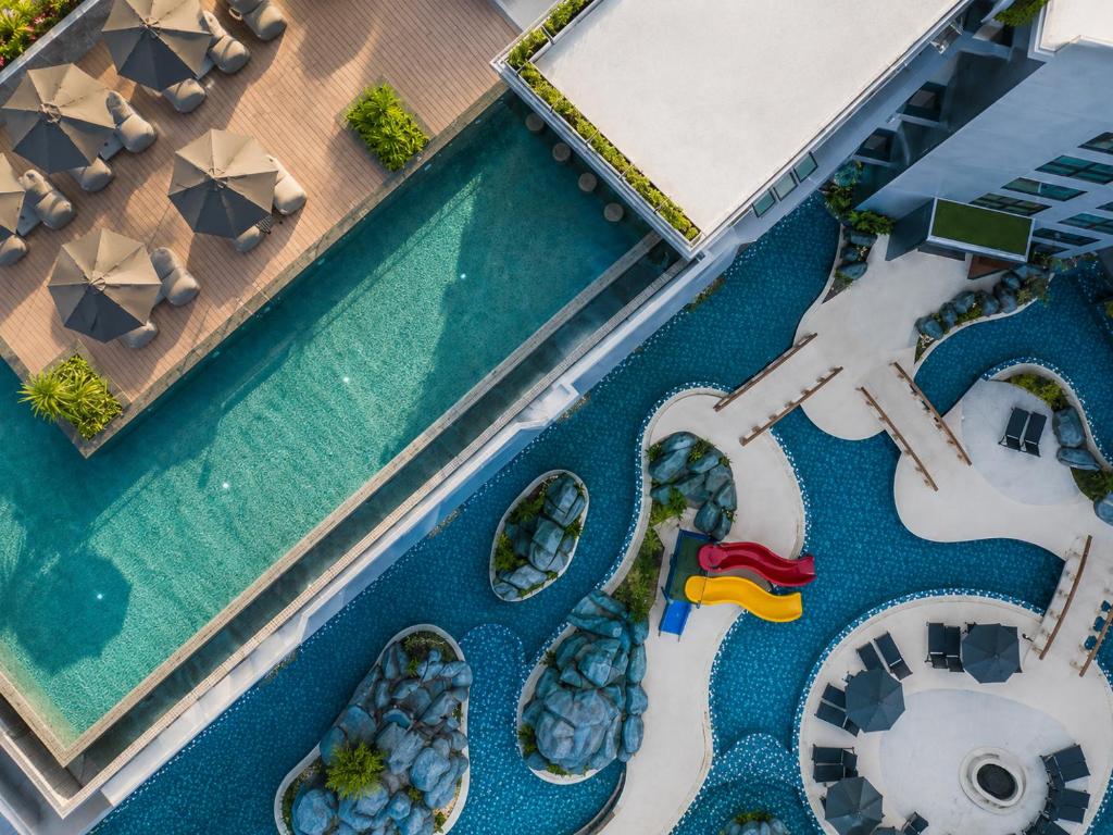 an overhead view of a swimming pool at a resort at Duplex Loft 5 Pools and Gym near Nai Harn Beach- UTL B119 in Rawai Beach
