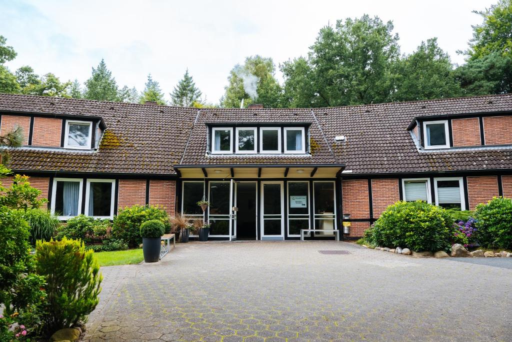 a brick building with a large glass door at Der Sunderhof in Seevetal