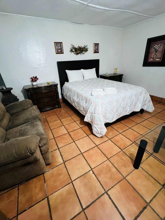 a bedroom with a bed and a couch at #5 Rancho Meling in Camalú