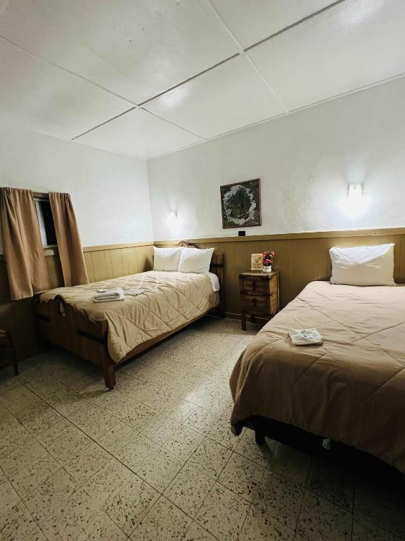a hotel room with two beds in a room at #4- Rancho Meling in Camalú
