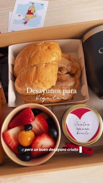 a box of food with a sandwich and fruit at kayac in Huánuco