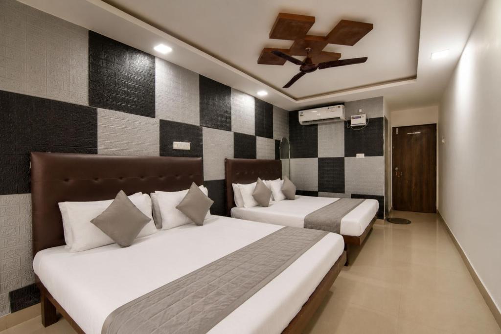 a bedroom with two beds and a ceiling at MogPrach Boutique in Calangute