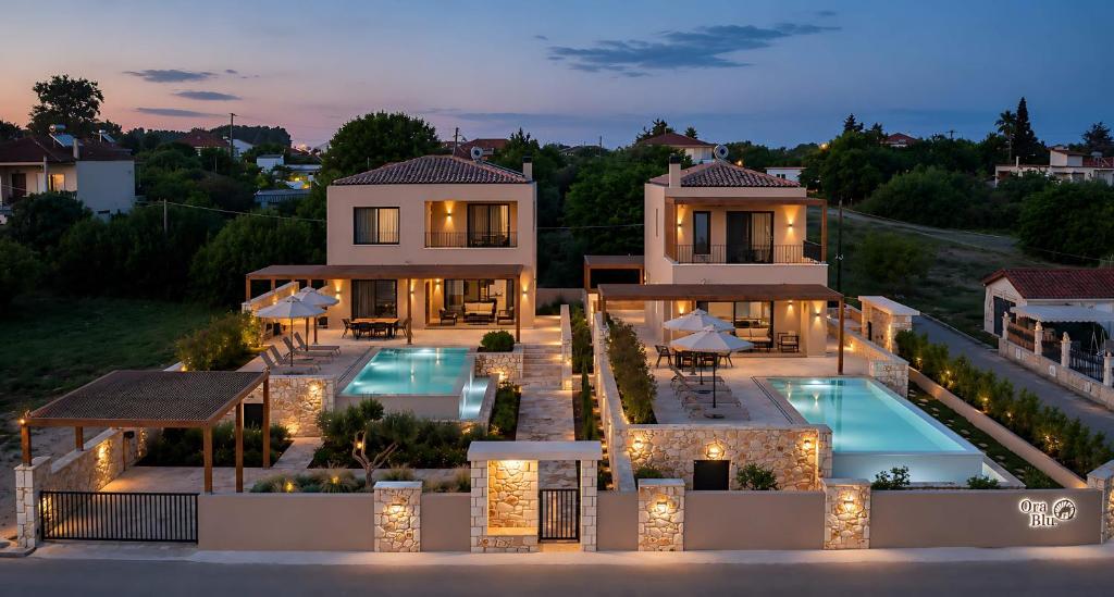 an aerial view of a house with a swimming pool at Ora Blu Villas in Mytikas