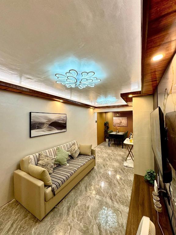 a living room with a couch in a room at Casa de Villanueva in Davao City