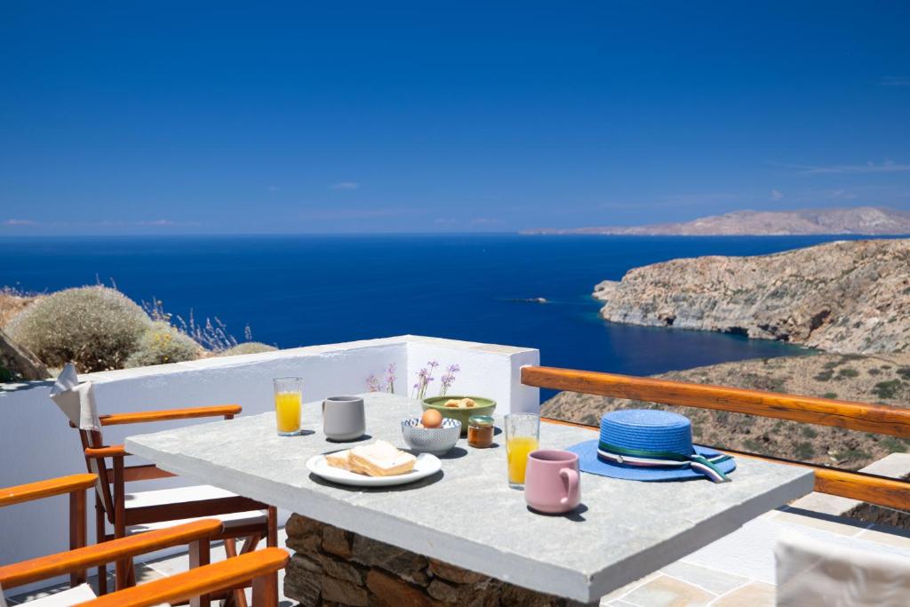 a table with food and a view of the ocean at Petala House in Cherronisos