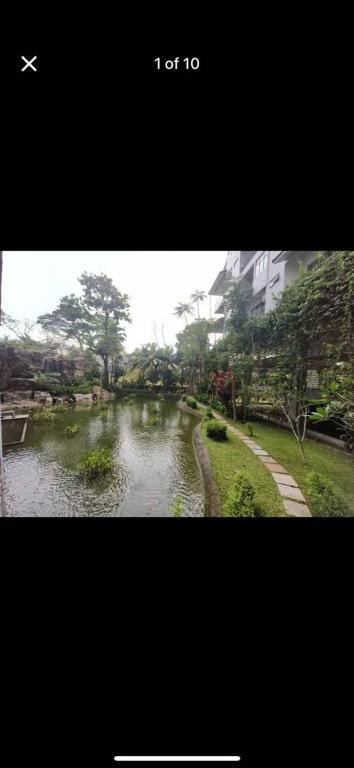 a picture of a river with an airplane flying over it at Anjung Seri Residence in Masai