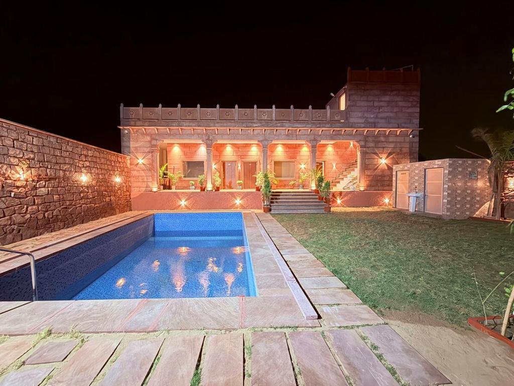 a house with a swimming pool at night at Nova Heaven Villa in Daijar
