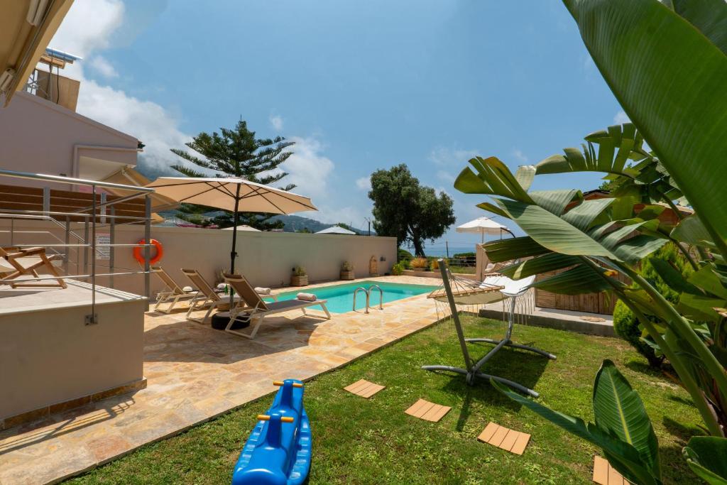 a backyard with a pool with a blue inflatable at Tsanta house in Agios Gordios