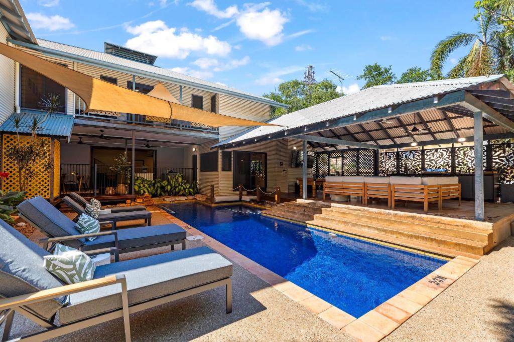 a house with a swimming pool next to a house at The Courthouse Bed & Breakfast in Broome