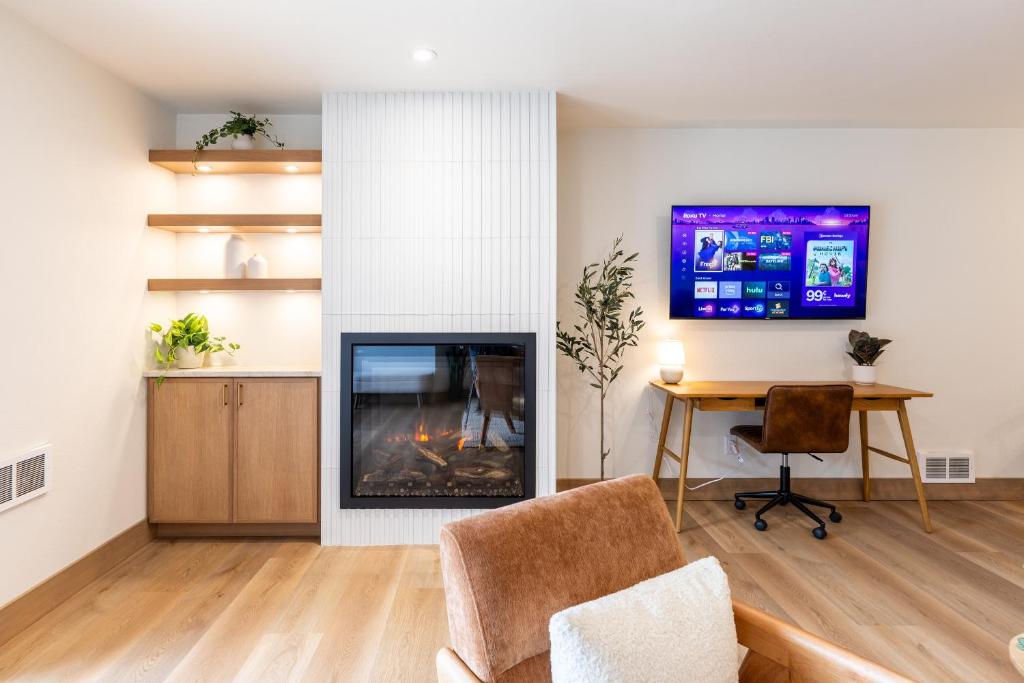 a living room with a fireplace and a table at Switchback at Edelweiss in Whitefish