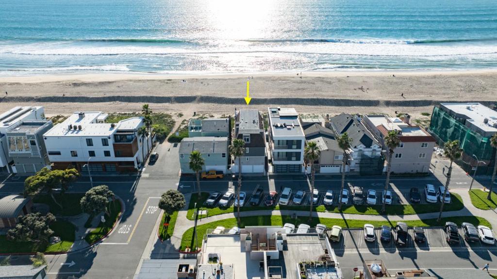 an aerial view of a beach with houses and the ocean at Beachfront Condo on A LowKey Beach in Sunset Beach