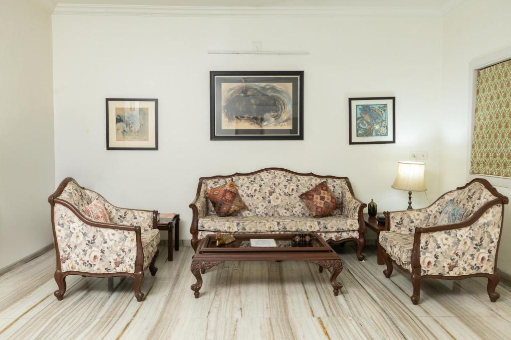 a living room with two chairs and a couch at Ishan Apartments 3BHK in Vadodara