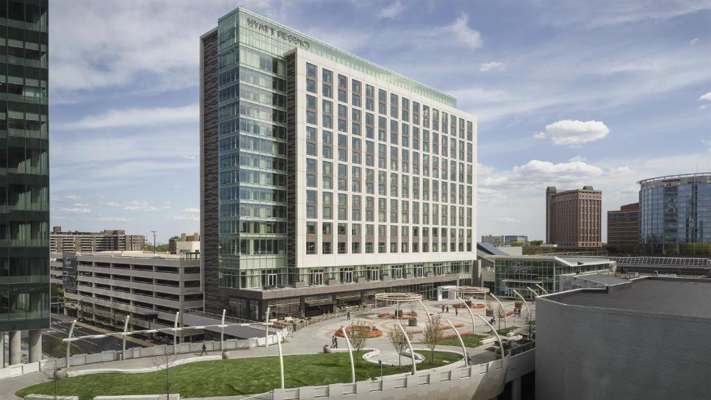 a tall glass building with a courtyard in front of it at Hyatt Regency Tysons Corner Center in Tysons Corner