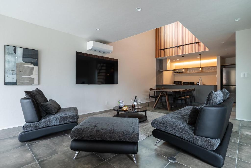 a living room with two chairs and a table at The Terrace MAKINO in Takashima
