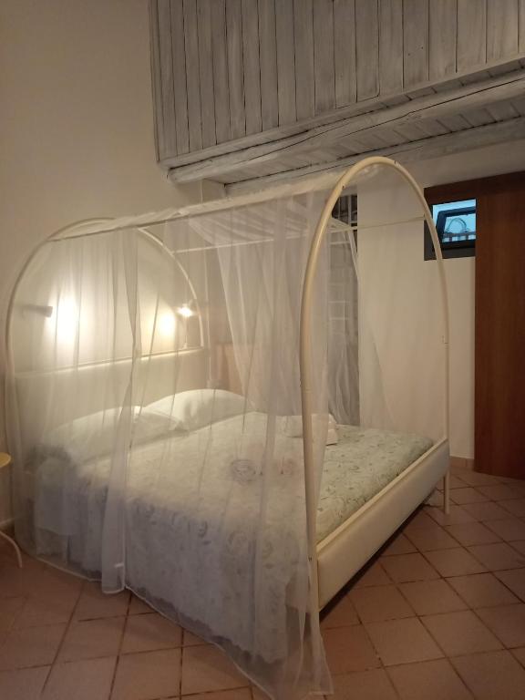 a bed with a canopy in a room at Curtigghiu Room in Avola