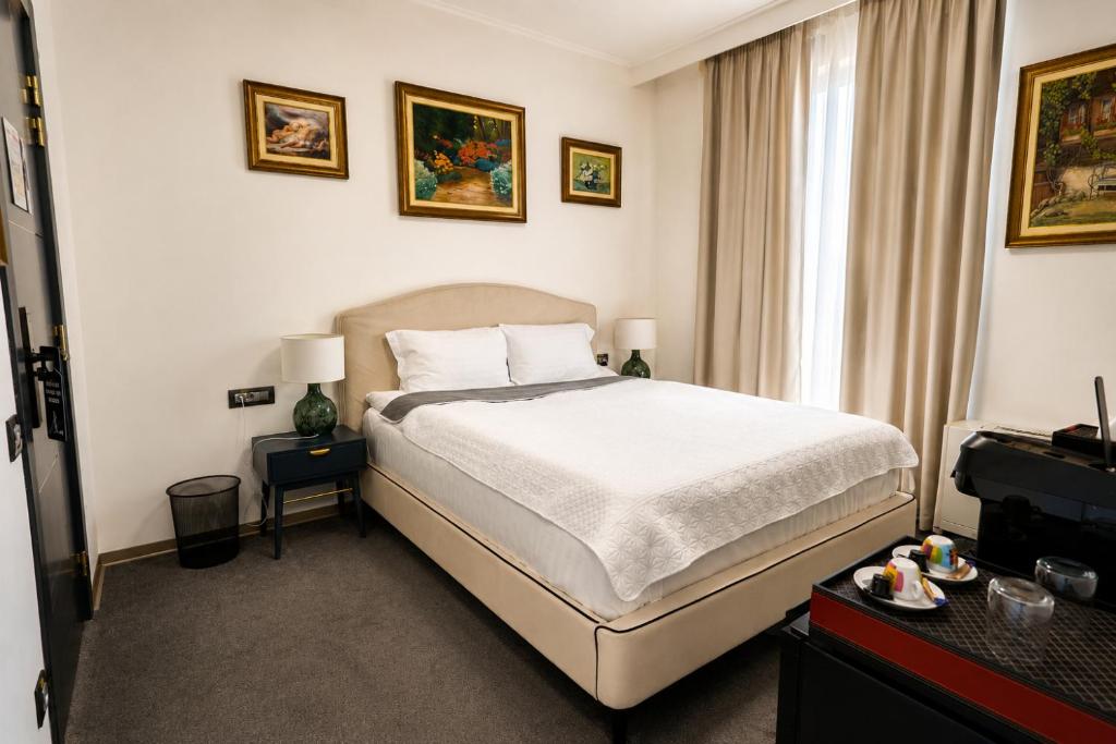 a hotel room with a bed and a window at The Square Hotel in Cluj-Napoca