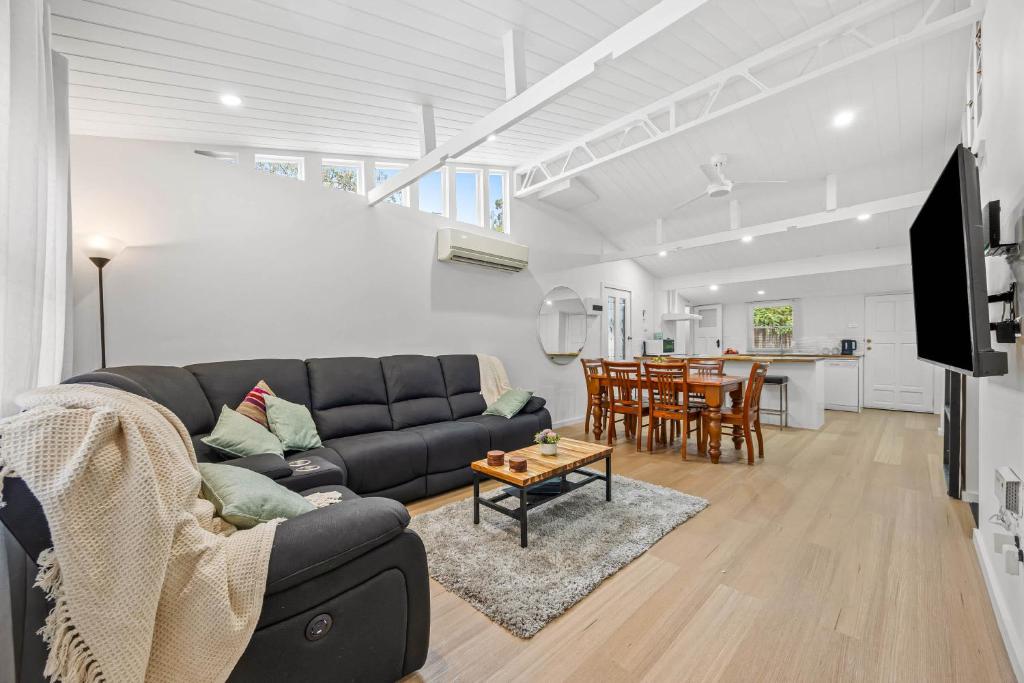a living room with a couch and a table at What-A-View Cottage Halls Gap in Halls Gap