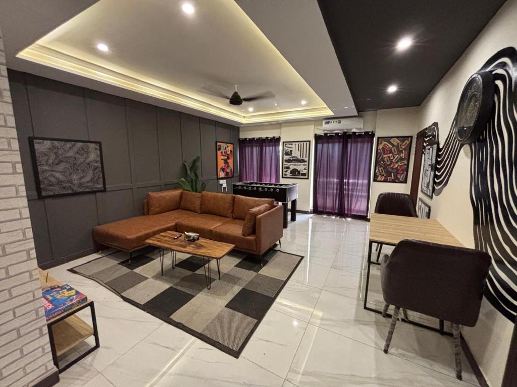 a living room with a couch and a table at Spacious Apartment by Urban Residence in Multan