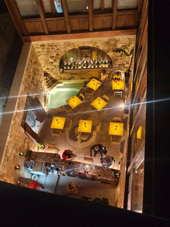 an overhead view of a restaurant with yellow tables and chairs at Jivaeri Luxury Suites in Rhodes Town